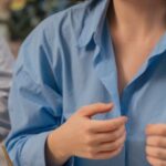 Family-Friendly - A woman smiling while eating food at a table