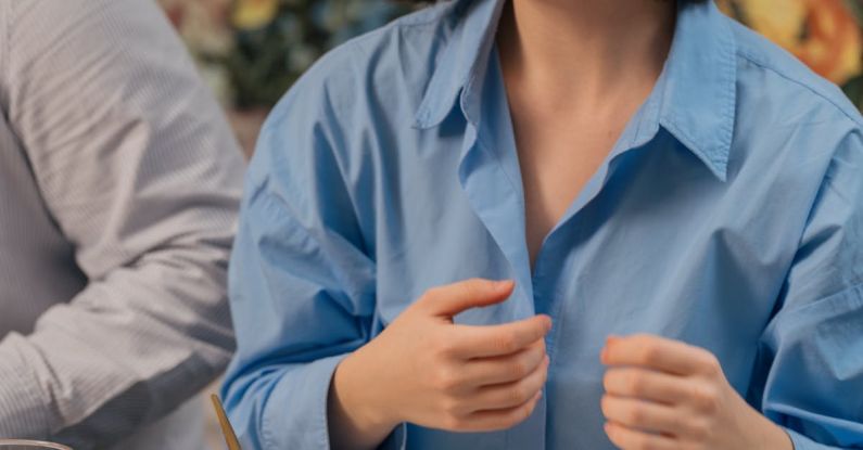 Family-Friendly - A woman smiling while eating food at a table