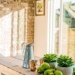 Luxury Items - Black Kettle Beside Condiment Shakers and Green Fruits and Plants on Tray on Brown Wooden Table