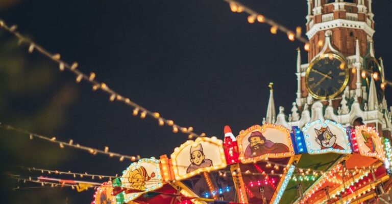 Temple Festivals - Colorful luminous carousel against Kremlin on Red Square at night