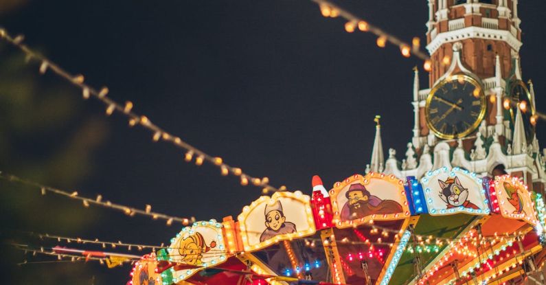 Temple Festivals - Colorful luminous carousel against Kremlin on Red Square at night