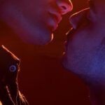 LGBTQ+ - Two men kissing in front of a bright light