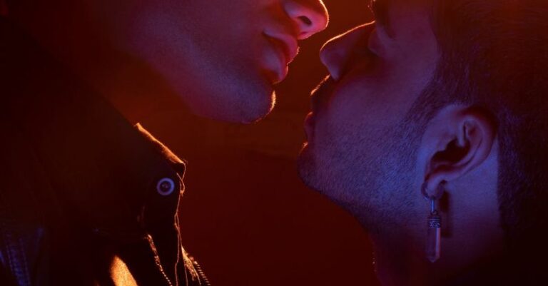 LGBTQ+ - Two men kissing in front of a bright light