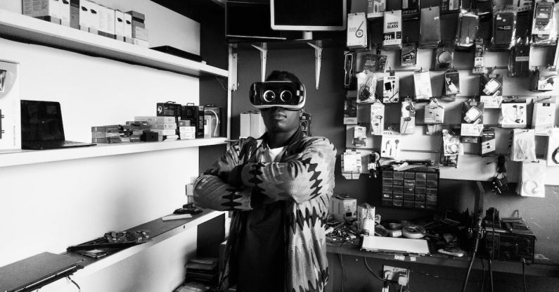 Local Experience - Black man in VR goggles in electronics store