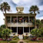 Urban Gardens - White Painted Structure With Green Palm Trees in the Front