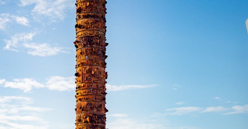 Public Art - A tall tower with a large wooden structure on top